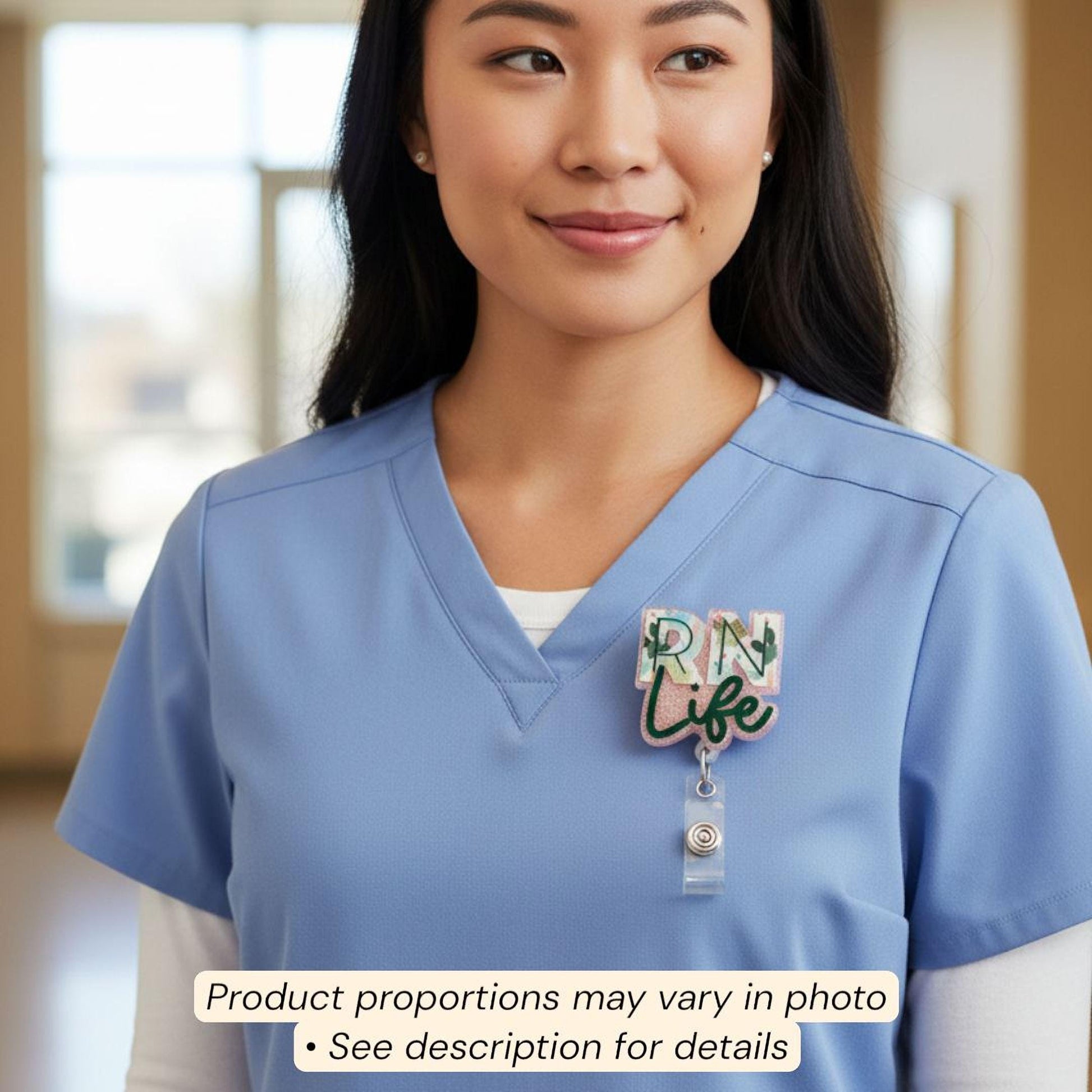 A woman wearing a blue nursing uniform with a badge that says "RN Life" on it.