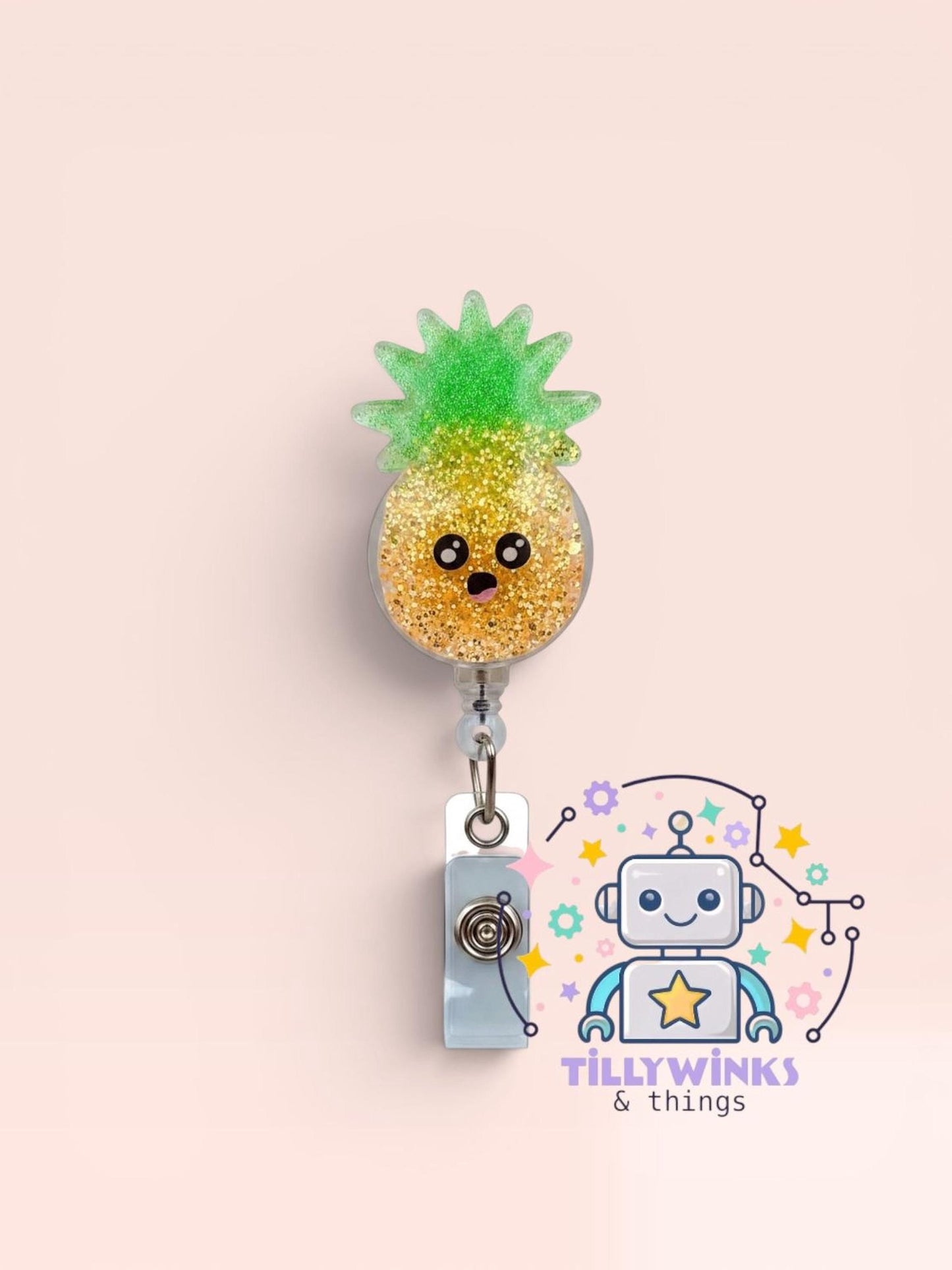 A colorful pineapple-shaped badge with a glittery pineapple design, hanging from a clip.