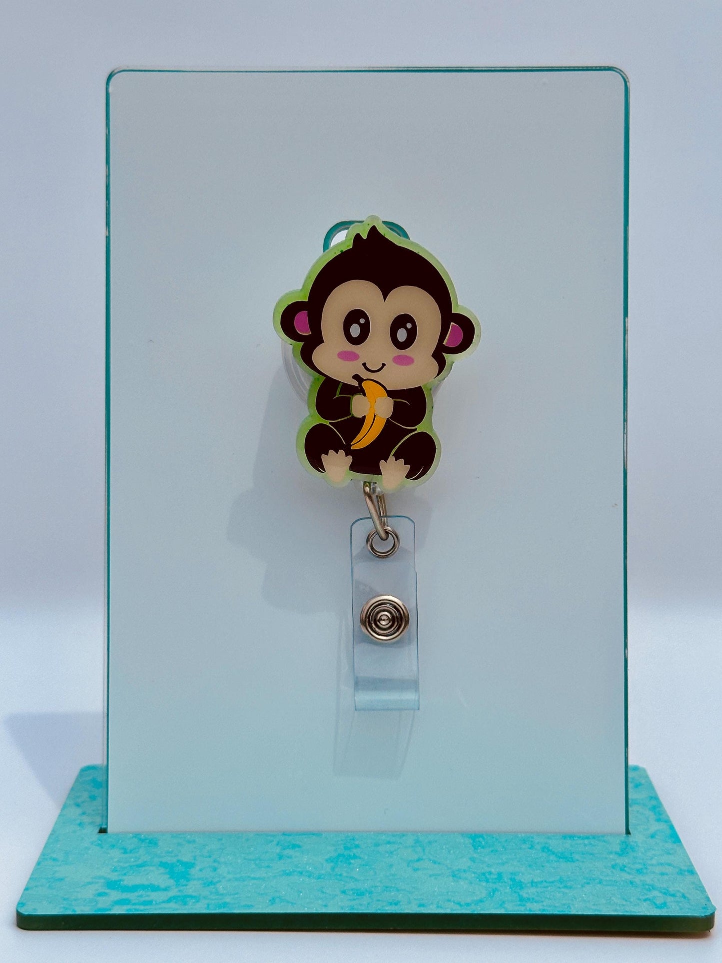 A cartoon monkey wearing a badge with a banana on it is displayed on a white background.
