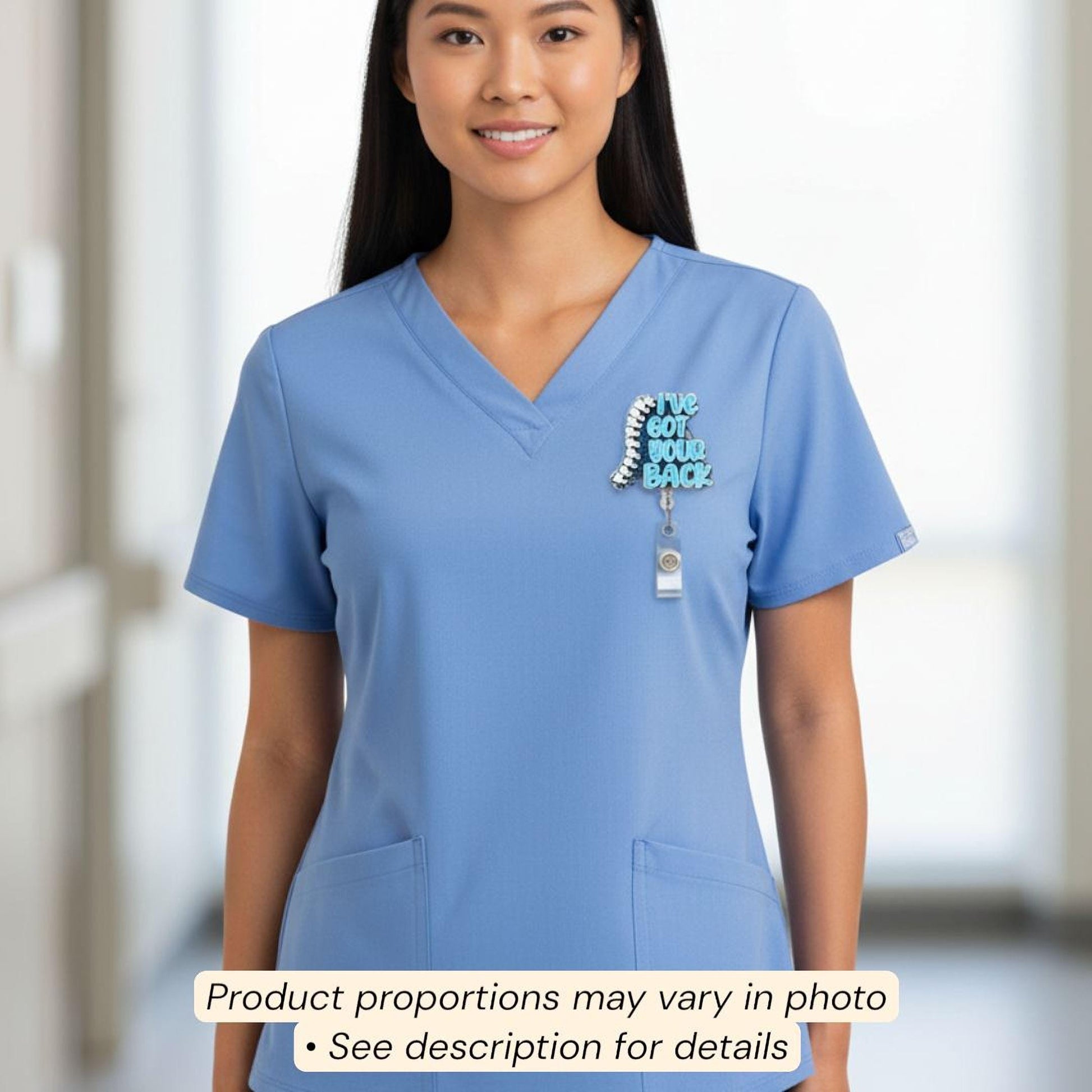 A smiling woman wearing a blue medical uniform with a spine-shaped badge on the left side of her chest.