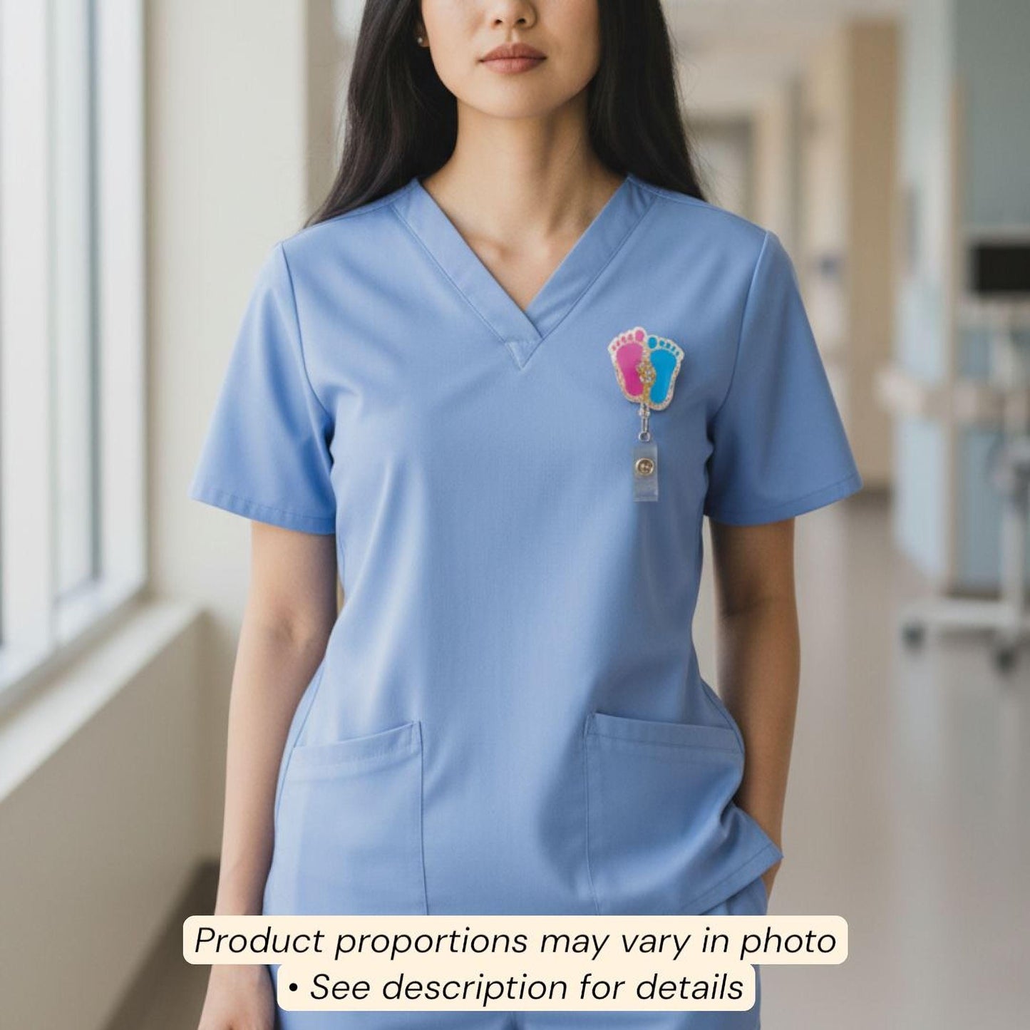 A woman wearing a blue medical uniform with a baby footprint badge on the left side of her chest.