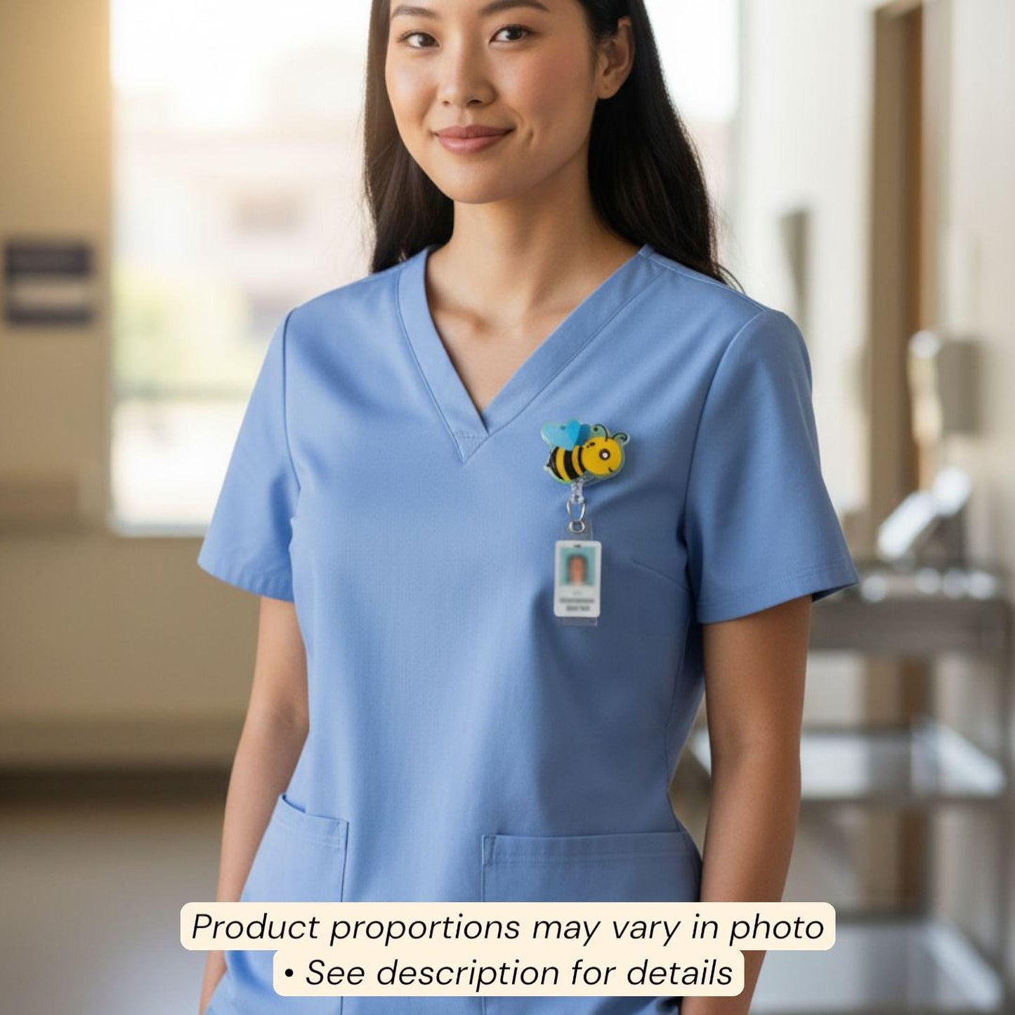 A smiling woman wearing a blue medical uniform with a bee-themed badge on the left side of her chest.
