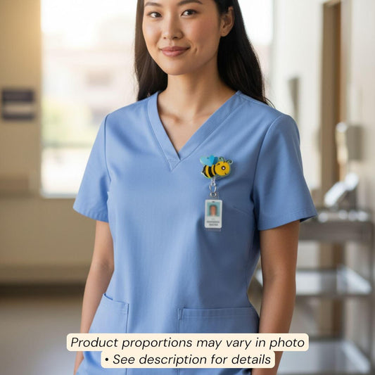 A smiling woman wearing a blue medical uniform with a bee-themed badge on the left side of her chest.