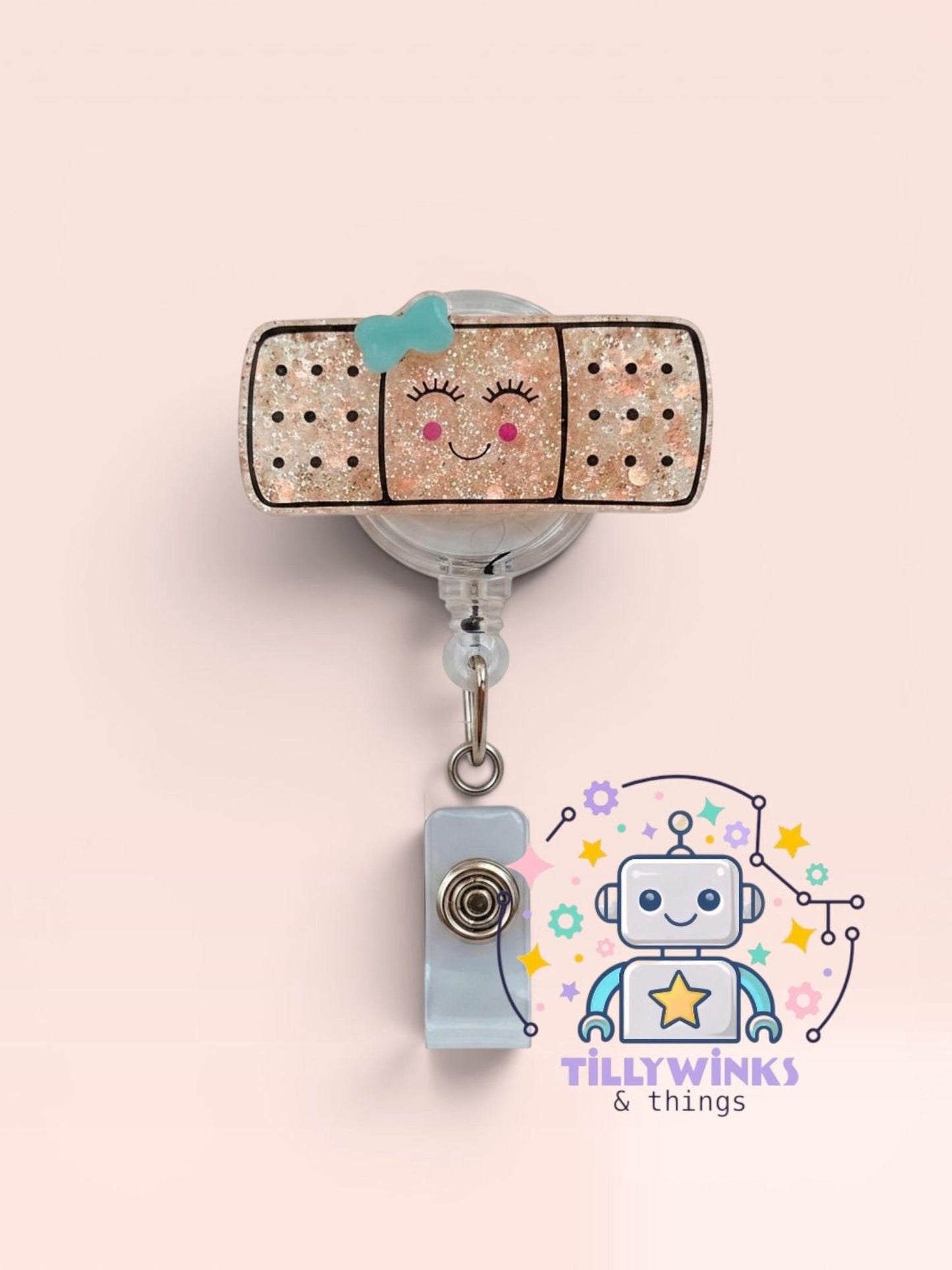 a clear badge holder with a glittery band and a robot-like character attached to it.
