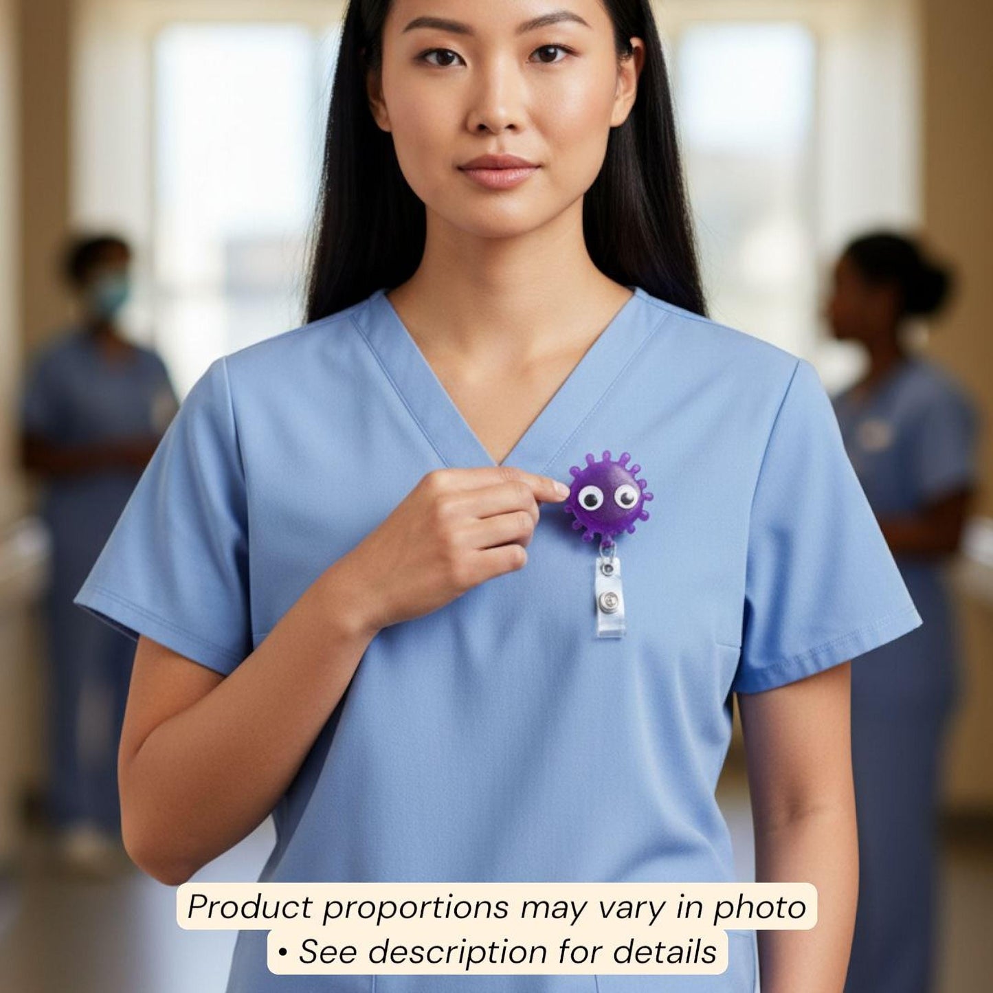 A woman in a blue medical uniform is holding a purple object with googly eyes, which appears to be a badge or lanyard.