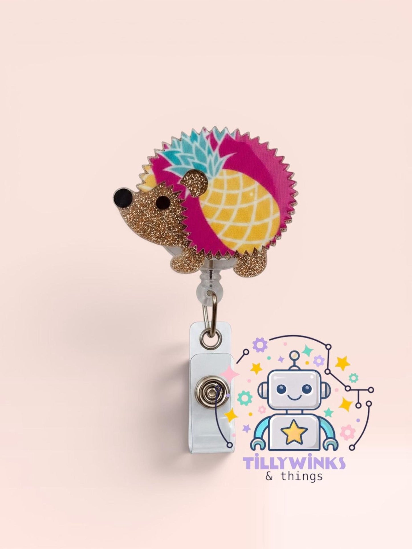 A colorful hedgehog-shaped badge holder with a glittery design, attached to a white clip. The background is a light pink color.