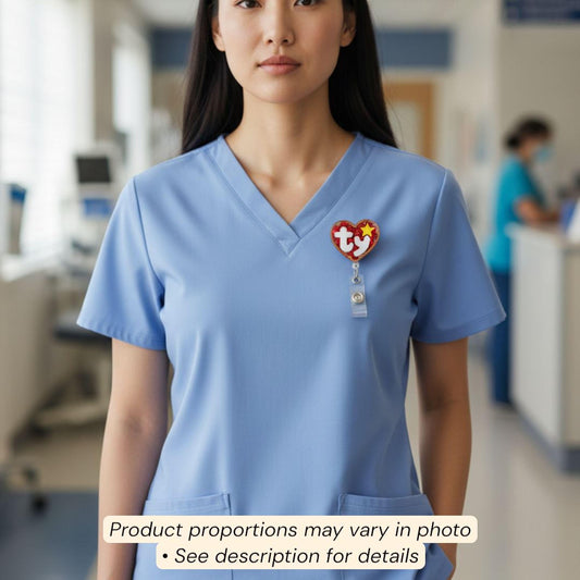 A woman wearing a blue medical uniform with a red and white Ty toy badge on her shirt.