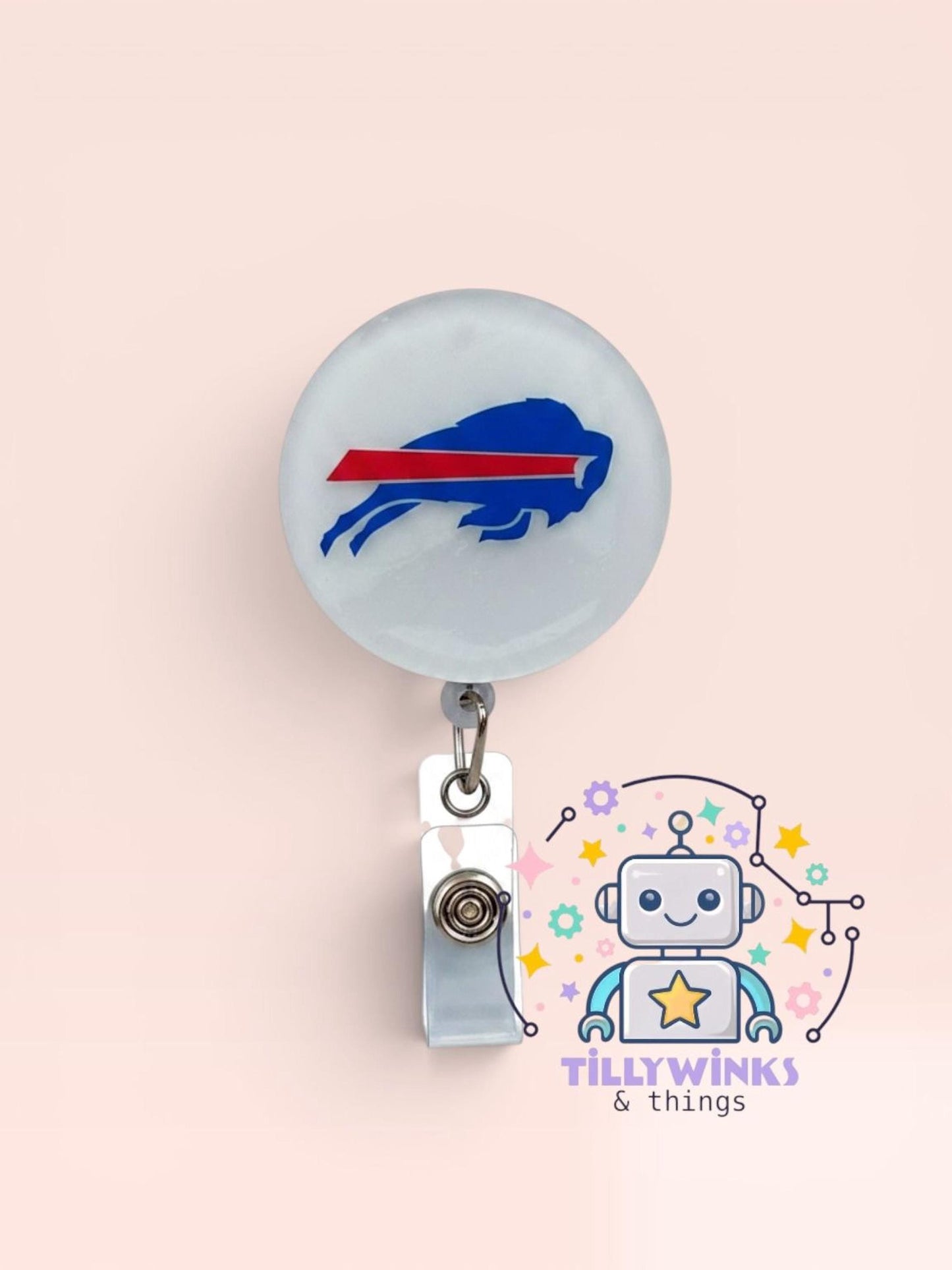 a badge with a buffalo buffalo logo on it, hanging from a clip. Below the badge, there is a cartoon robot with a star and a smiley face.