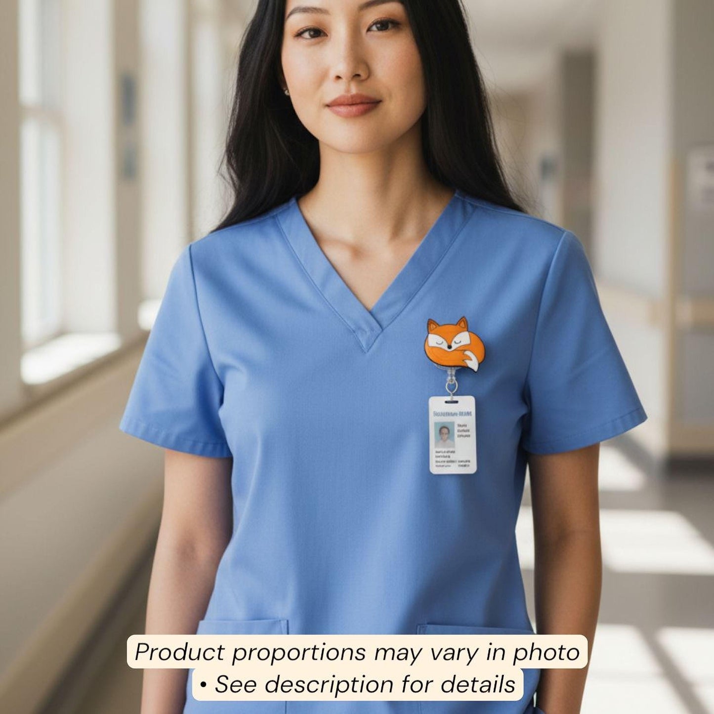 A woman wearing a blue medical uniform with a cat badge on the left side of her chest.