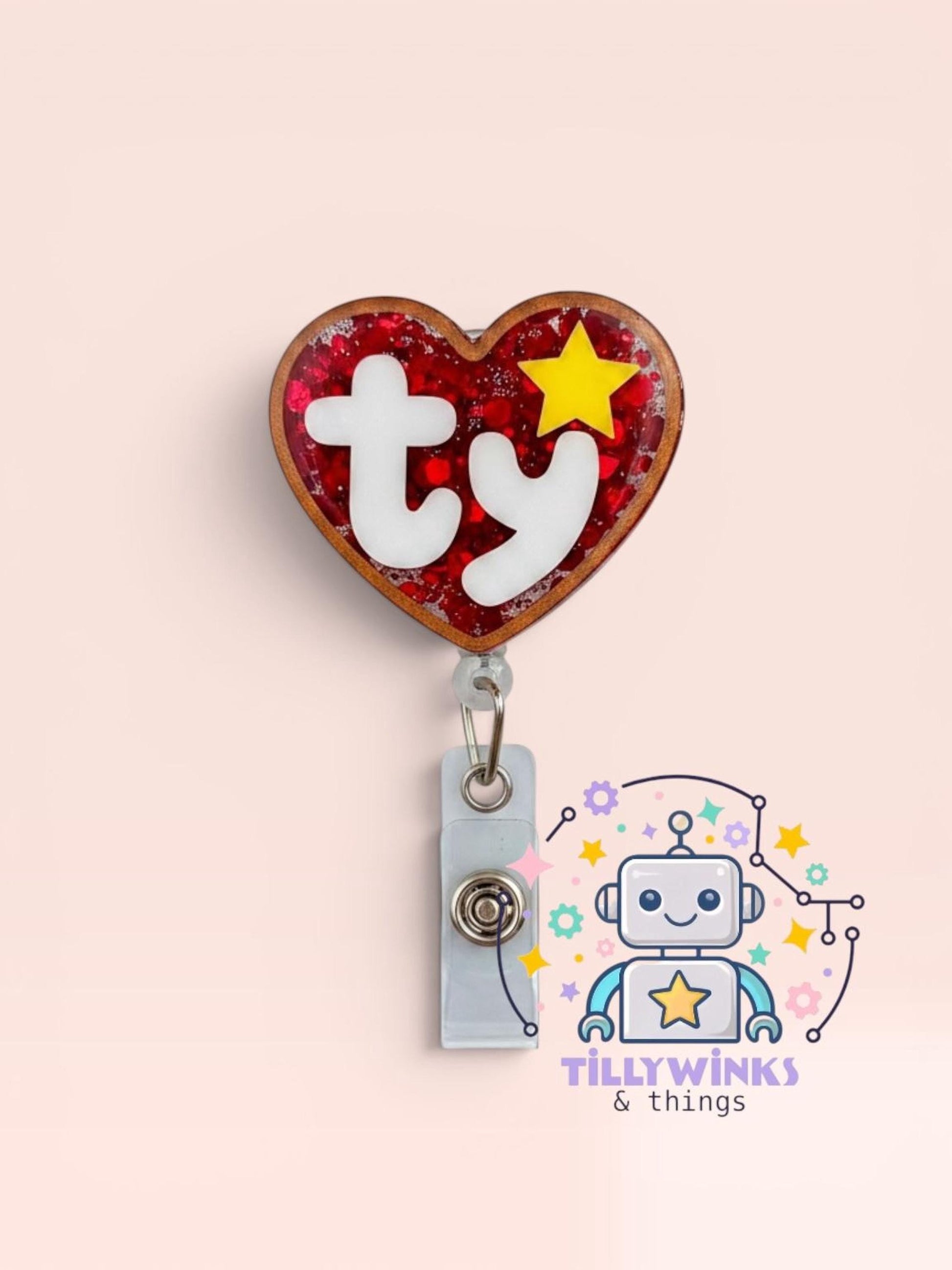 A red heart-shaped badge with the word 'ty' inside, attached to a gray clip, and a robot-like character with a star in the background.