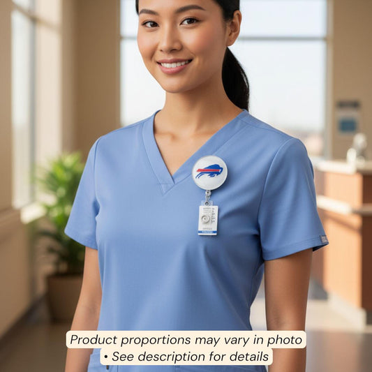 A smiling woman wearing a blue medical uniform with a badge on her shirt.