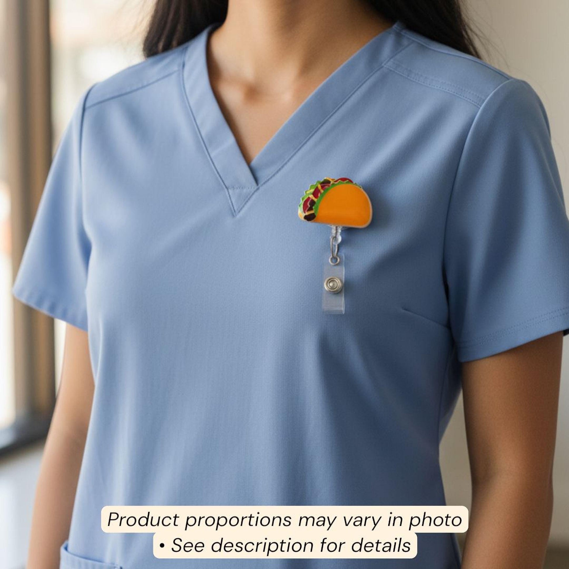 A person wearing a blue medical uniform with a small, colorful taco-shaped badge on the left side of the chest.