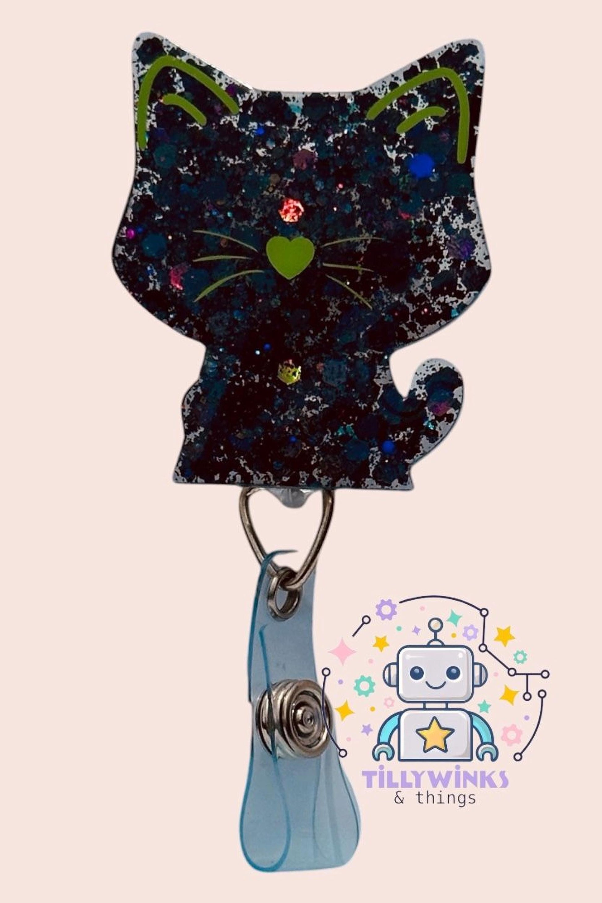 A black cat-shaped badge with a heart-shaped eye and a robot-like character in the background.