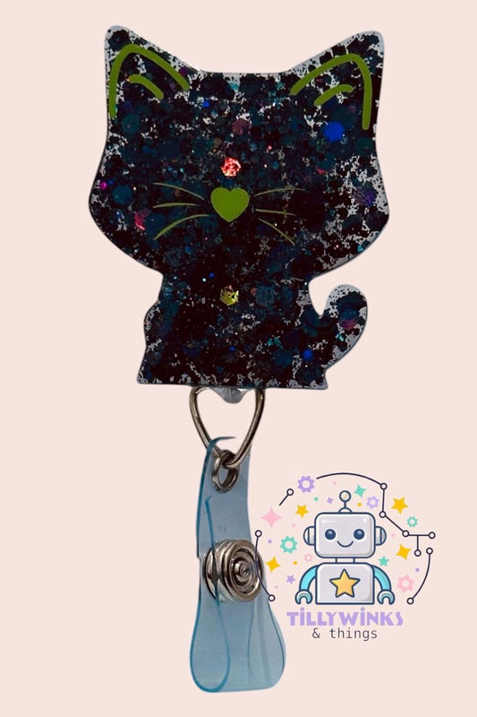 A black cat-shaped badge with a heart-shaped eye and a robot-like character in the background.