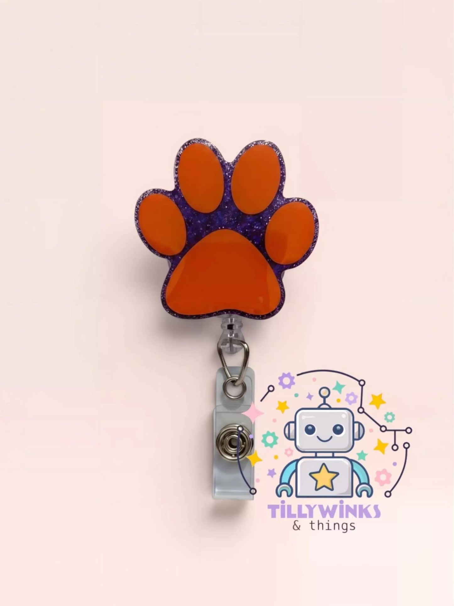 a colorful and whimsical cat paw-shaped badge holder with a clip, attached to a wall.