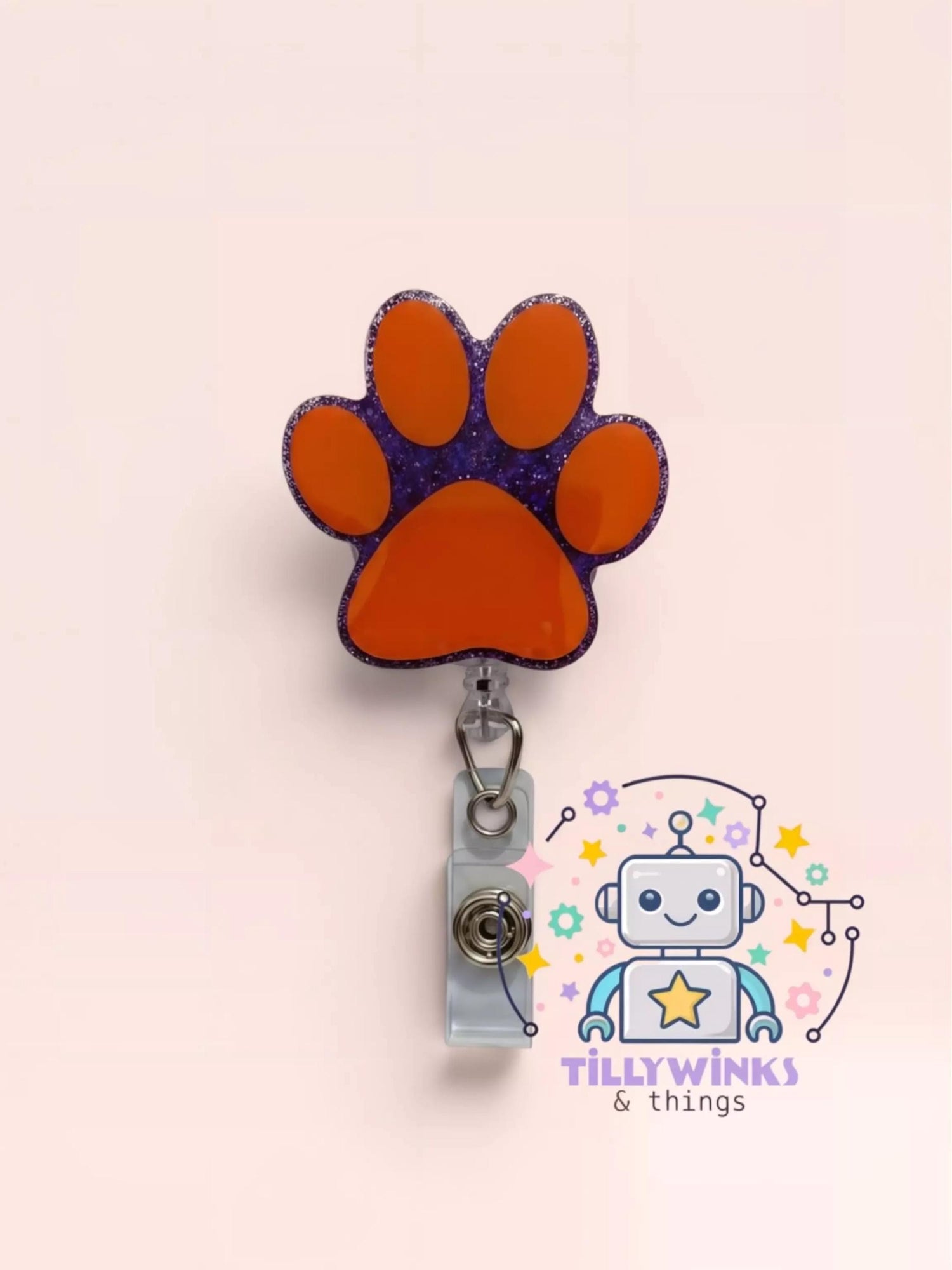 a colorful and whimsical cat paw-shaped badge holder with a clip, attached to a wall.